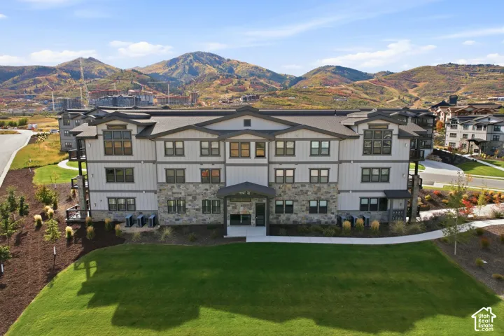 Contemporary multi-story property featuring a stone and siding exterior