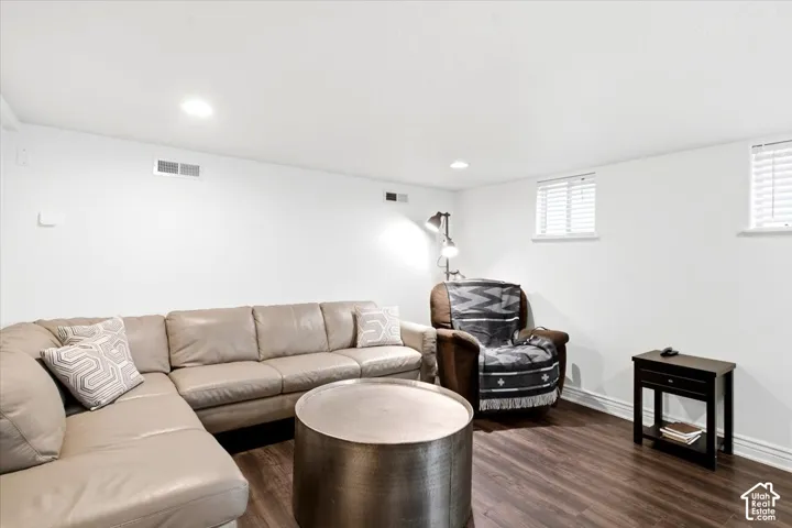 Wood-finish flooring, recessed ceiling lighting, and white walls