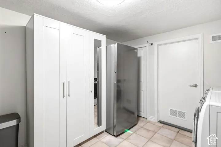 White cabinetry with brushed nickel hardware and mirrored door panel