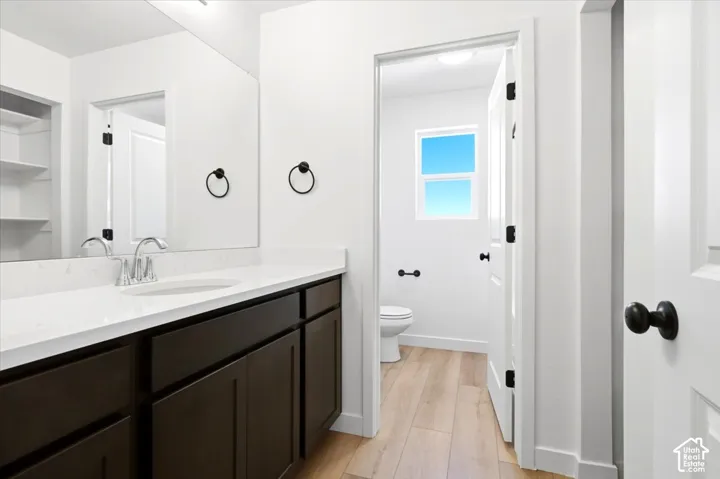 Bathroom vanity with a white countertop and dark cabinetry