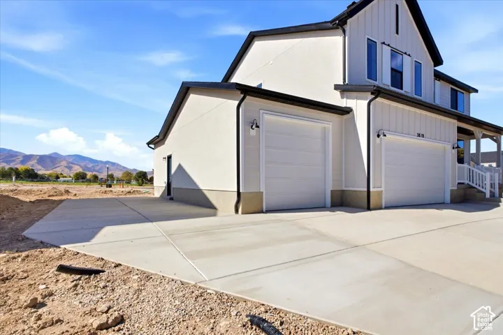 Contemporary exterior featuring white board and batten and stucco siding