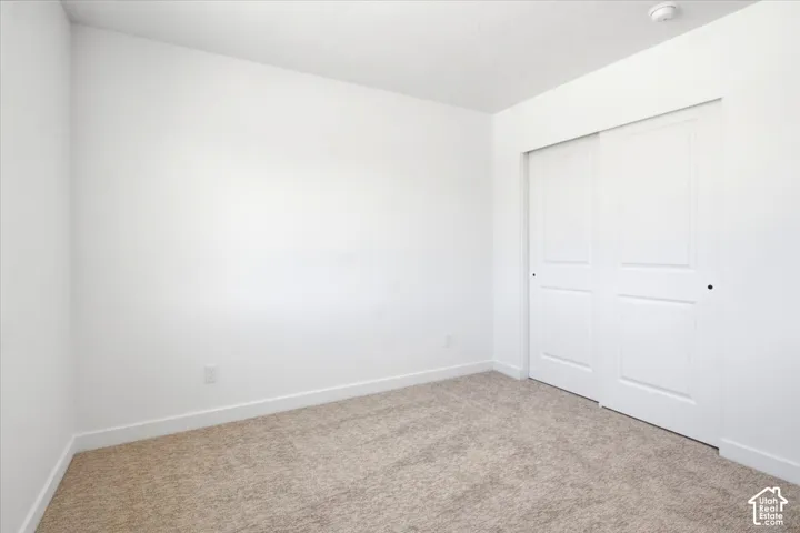 Neutral-toned carpet flooring and white walls