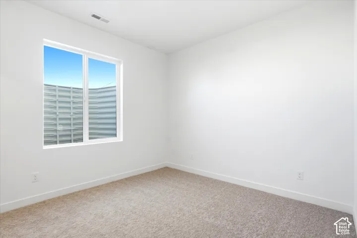 Bright interior space with light-toned carpeting and white walls