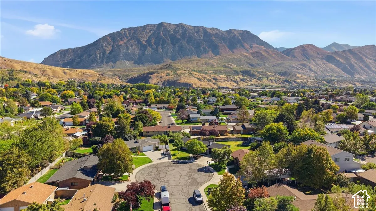 Expansive residential area with mature trees, a cul-de-sac, and prominent mountain backdrop