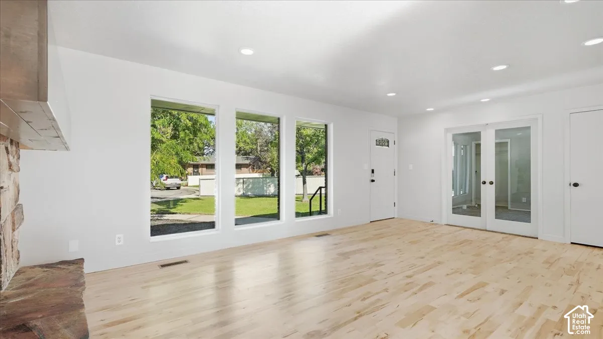 Light wood-finish flooring with recessed lighting