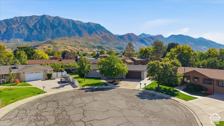 Cul-de-sac location with mountain backdrop, surrounded by lush green lawns and mature trees
