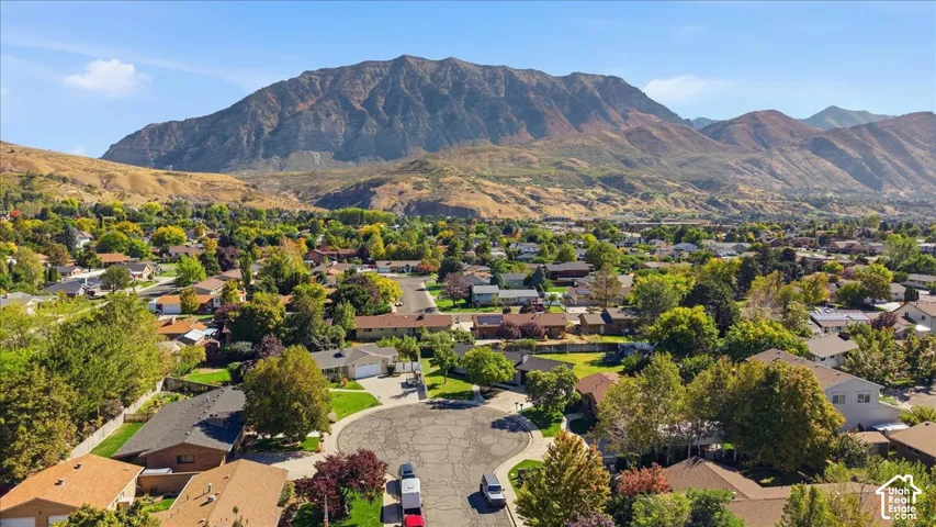 Expansive residential area with mature trees, a cul-de-sac, and prominent mountain backdrop