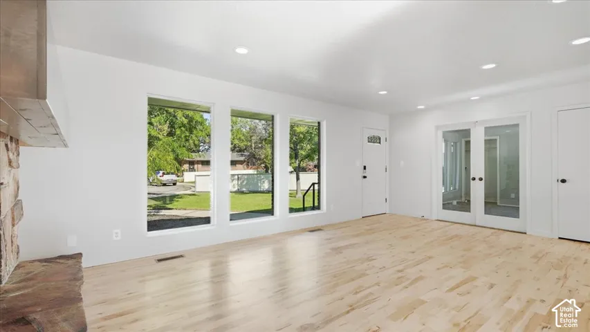 Light wood-finish flooring with recessed lighting