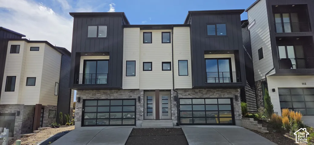 Modern exterior featuring stone veneer, vertical panel siding, horizontal plank siding, multiple balconies, and multiple two-car garages with glass panel doors