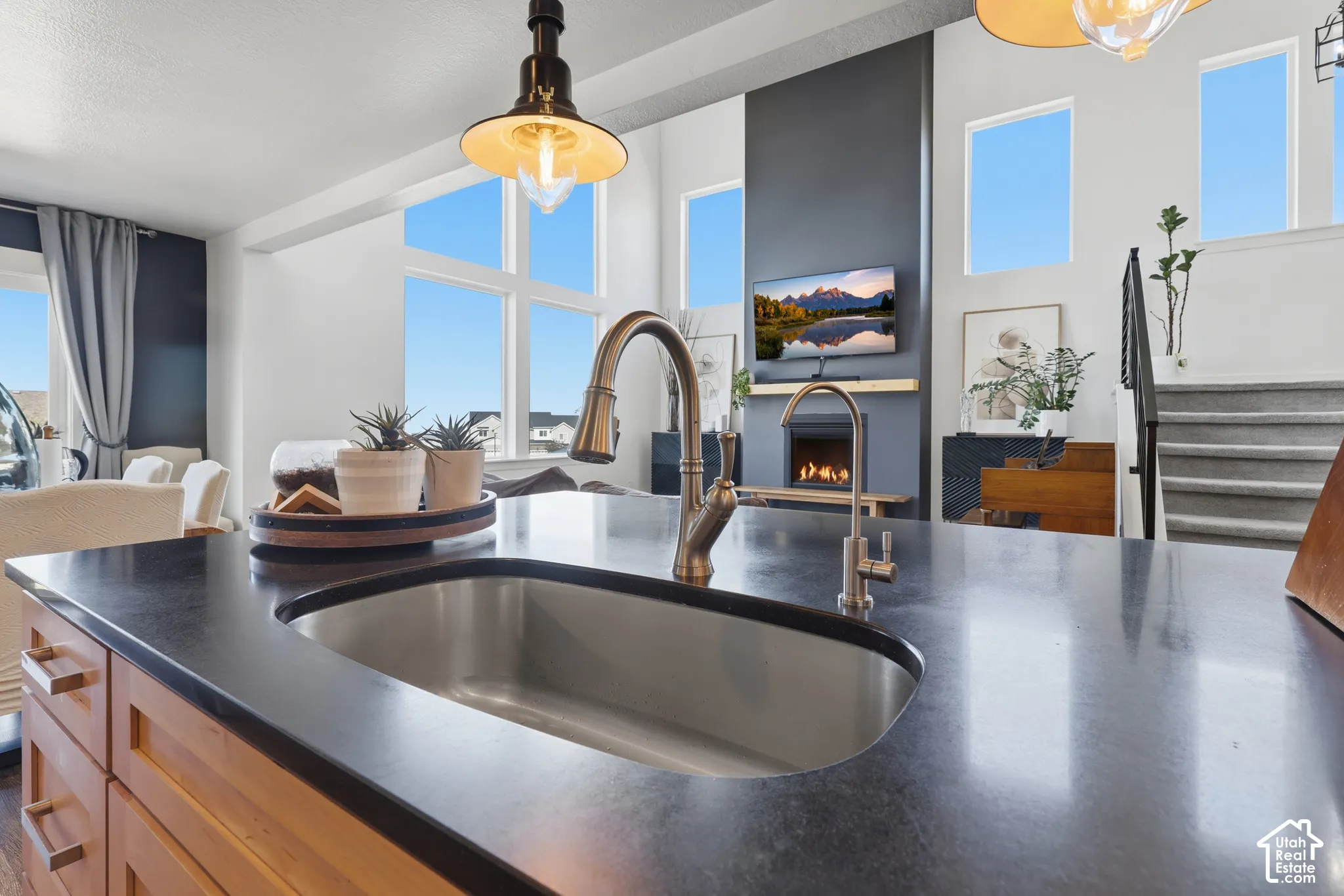 Kitchen island with an undermount stainless steel sink and a bronze-finish faucet