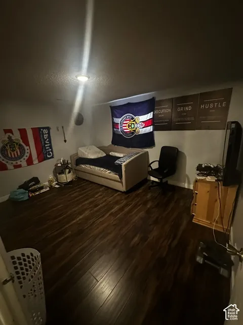 Recessed ceiling lighting illuminates wood-finish flooring