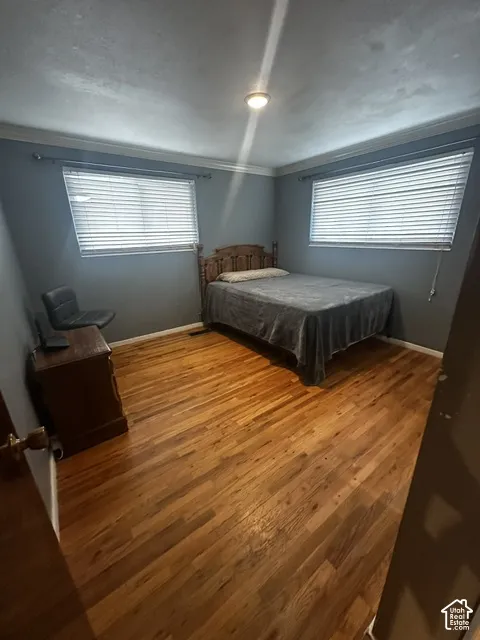 Wood-finish flooring throughout, complemented by two windows with blinds