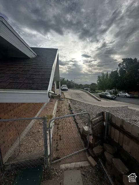 Brick exterior with dark shingle roofing