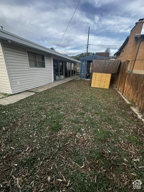 Expansive yard space with a wood fence perimeter