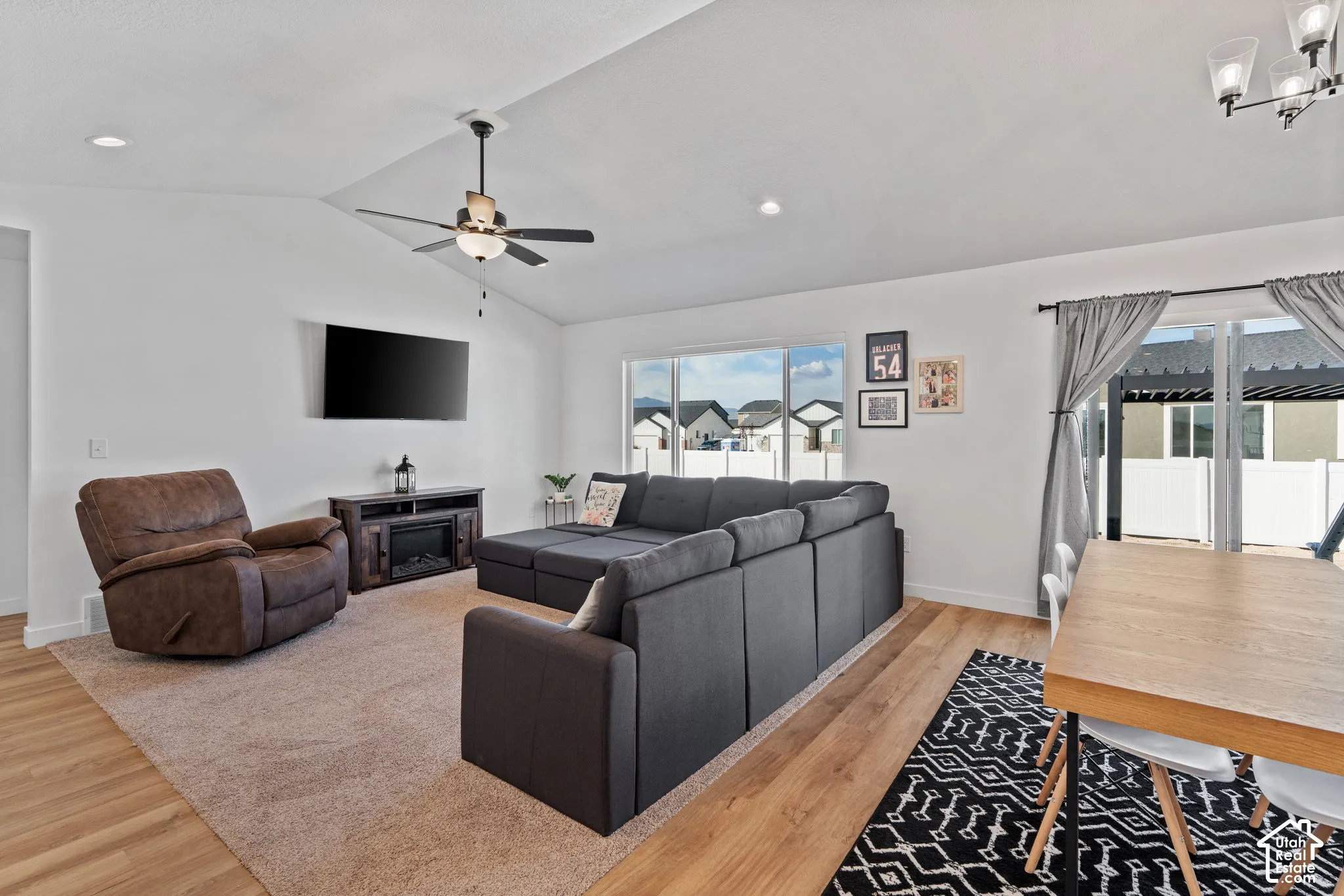 Vaulted ceiling with recessed lighting and ceiling fan