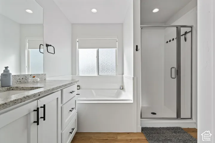 White vanity with light-toned countertop, integrated sink, and dark-finish hardware