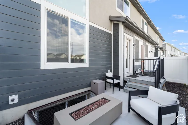 Private concrete patio featuring a fire pit