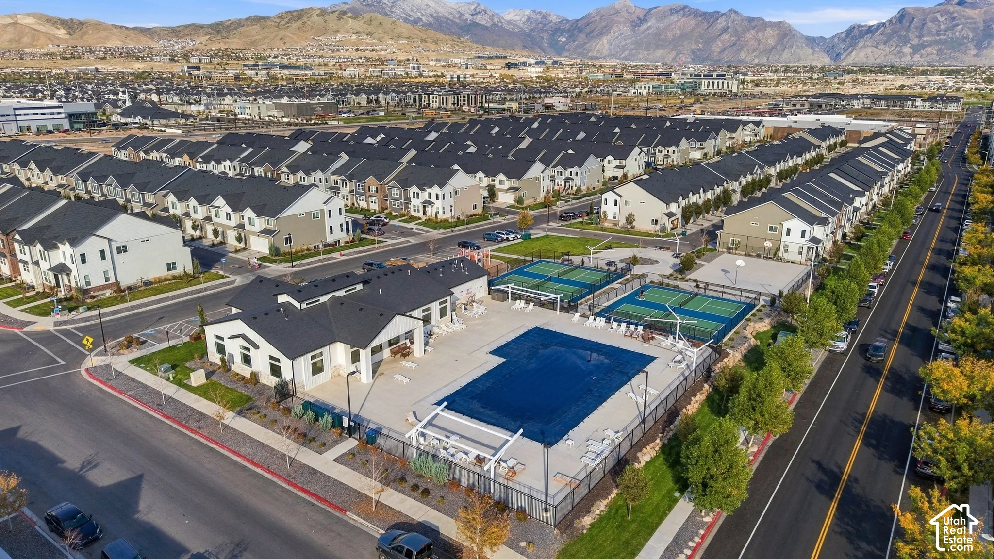 Community recreation center featuring a swimming pool, two tennis courts, and a clubhouse building