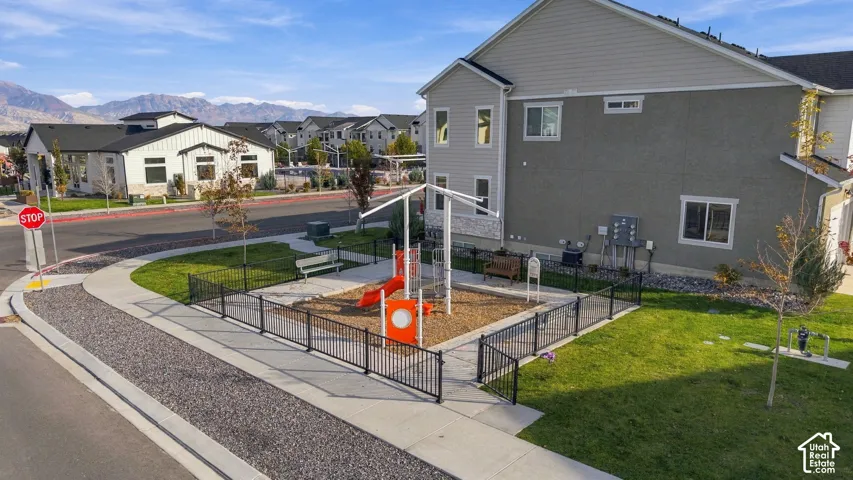 Community playground with fenced perimeter and seating areas