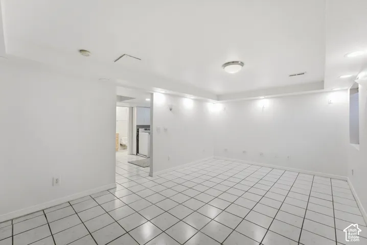 White tile flooring, recessed lighting, flush-mount ceiling light, and a window