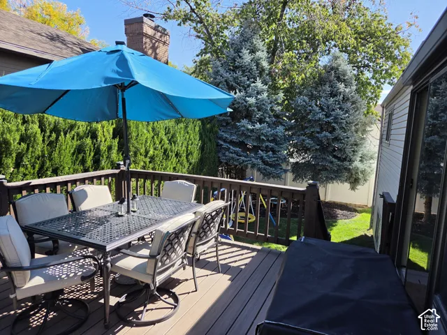 Spacious wood-finish deck with dark wood-finish railing