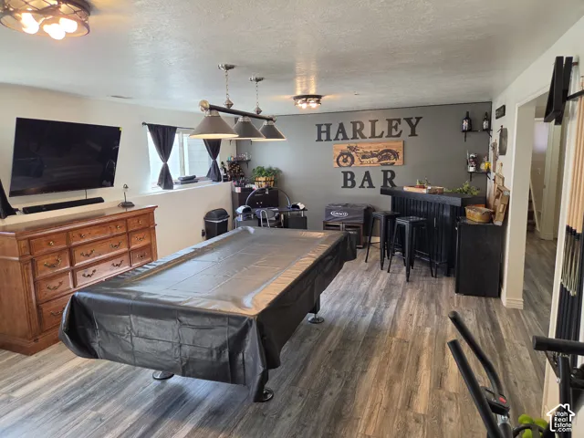 Wood-finish flooring throughout, a built-in bar, and recessed windows with sills