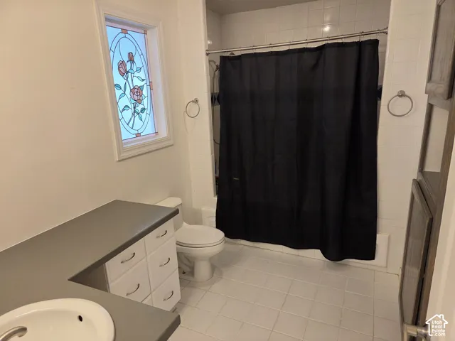 White tiled flooring and shower surround