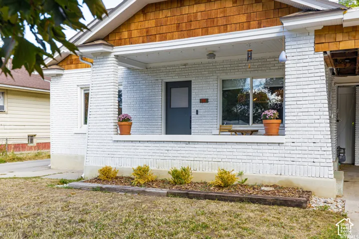 White brick exterior with a covered front porch