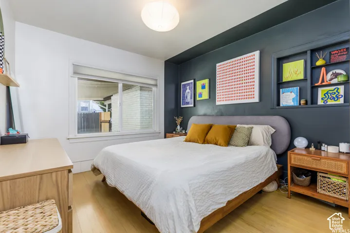Recessed wall shelving, light wood-finish flooring, and a large window with white trim