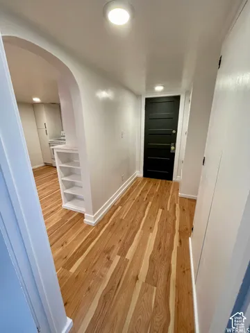 Wood-finish flooring throughout, framed by white baseboards