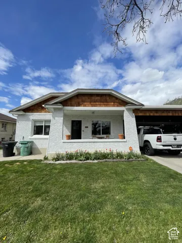 White brick exterior with wood shingle accents