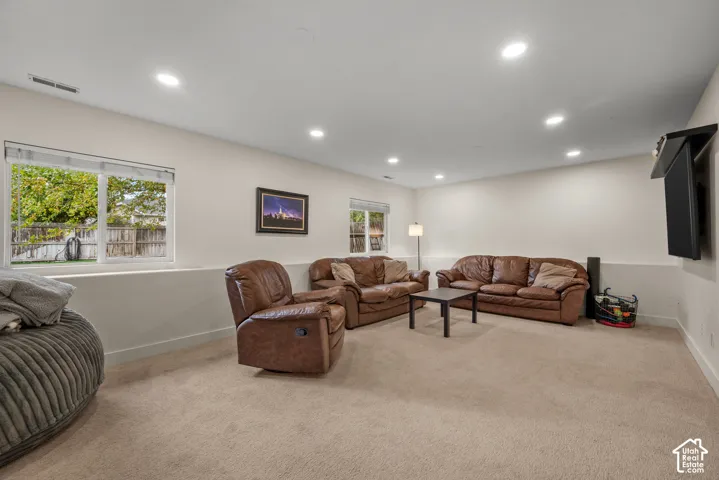 Recessed lighting, light-colored walls, and windows provide illumination