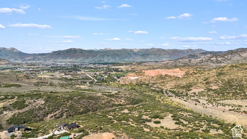 Expansive mountainous terrain with distant urban development