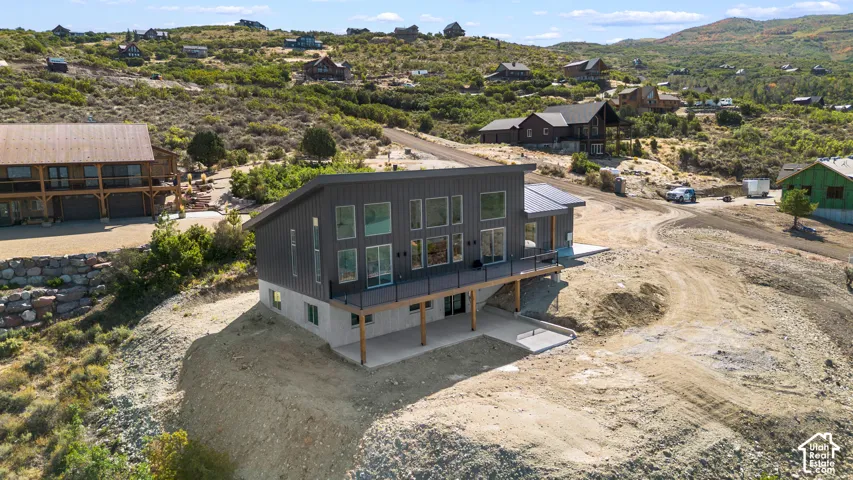 Contemporary residence featuring a dark gray vertical siding exterior and a sloped roofline