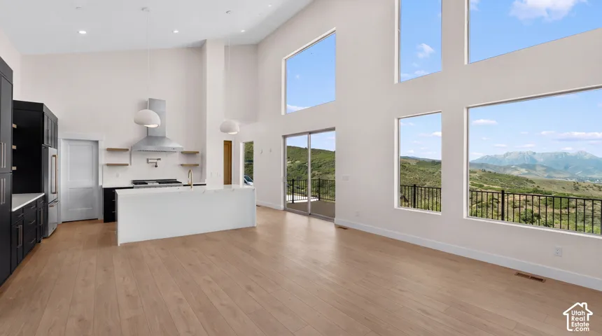 High ceilings complement the light wood-finish flooring