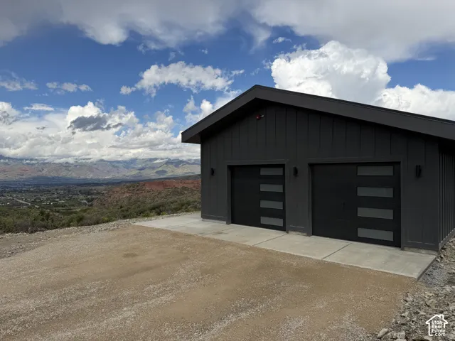 Two-car garage featuring contemporary doors with horizontal glass panels