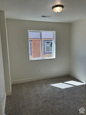 Recessed window with white trim, wall-to-wall carpeting, and a flush mount ceiling light