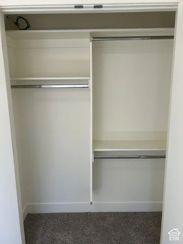 Built-in closet system with shelving and hanging rods