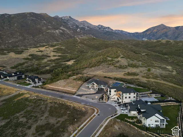 Mountain-backed property with a paved cul-de-sac and multiple residences