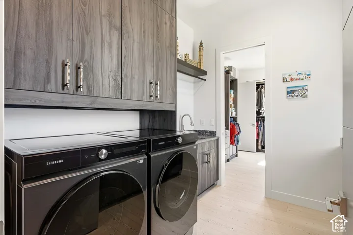 Laundry area with wood-finish cabinetry, a sink, and a countertop