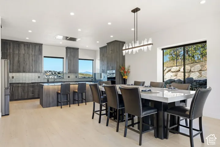 Open-concept kitchen and dining area featuring light wood-finish flooring