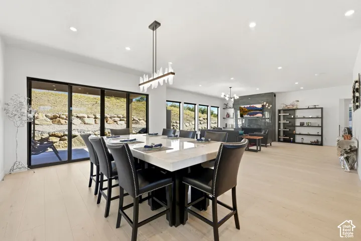 Expansive open-concept living area featuring light wood-finish flooring and recessed lighting