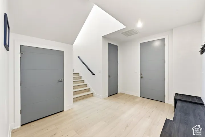 Light wood-finish flooring with white walls