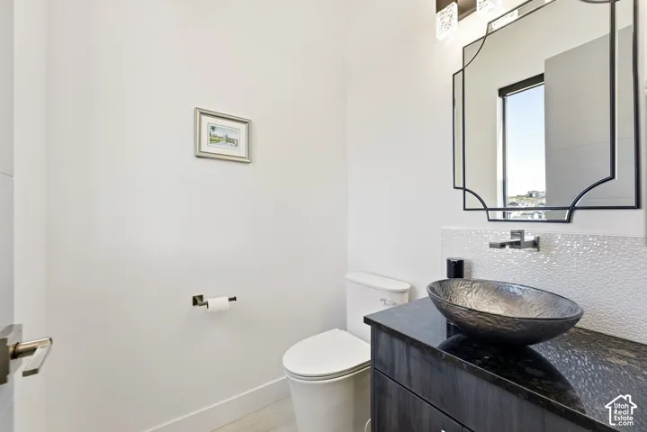 Dark wood-finish vanity with a dark countertop