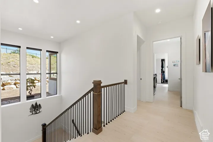 Staircase with wood-finish handrail and black metal balusters