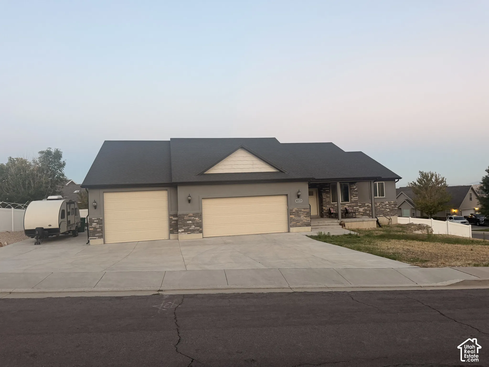 Siding exterior with stone accents and a covered entry