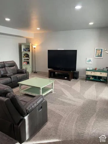 Recessed lighting, patterned carpet, and built-in shelving