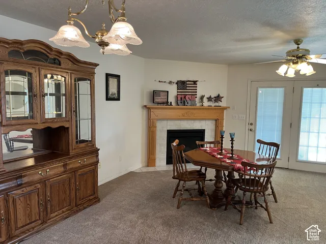 Corner fireplace with a wood mantle and tile surround