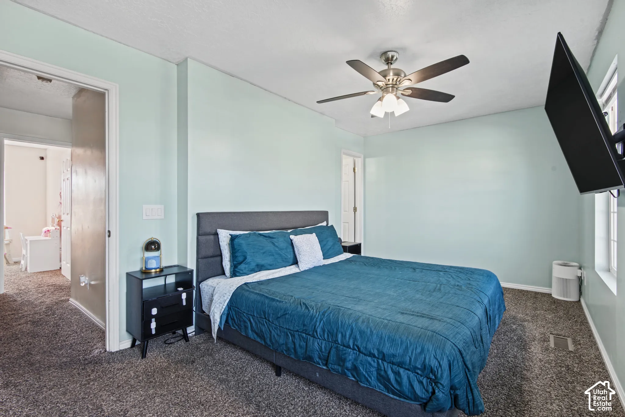 Recessed lighting, light blue wall paint, ceiling fan, and carpet flooring