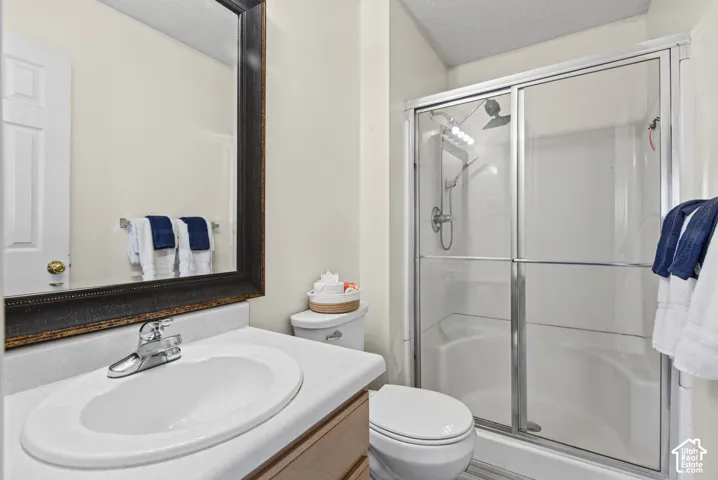 Bathroom featuring a chrome faucet, white oval sink, and a framed mirror